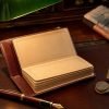 Vintage leather passbook with fountain pen and brass desk lamp on mahogany, editorial still-life for PPF account rules