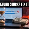 Hourglass on a laptop with a stalled e-filing bar and blocked rupee refund arrow, income tax refund delay fixes India 2026